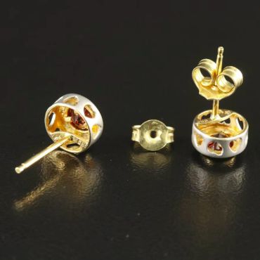 Gold and silver stud earrings with butterfly backs.
