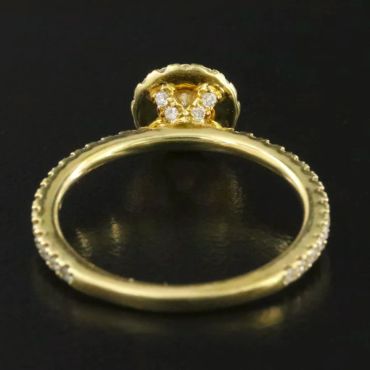Golden ring with diamonds on black background.
