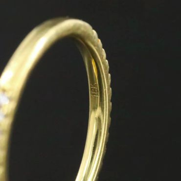 Close-up of an 18K gold ring hallmark.