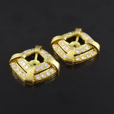 Gold earrings with embedded diamonds.