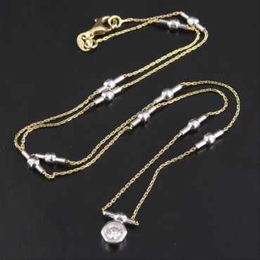 Elegant gold and silver necklace with unique beads.