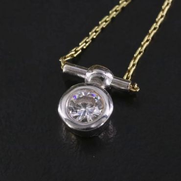 Gold chain with a silver and diamond pendant.