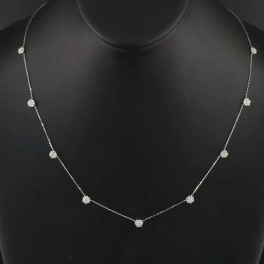 Delicate silver necklace with small flower-shaped charms.