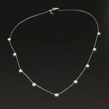 Delicate silver necklace with small gemstone beads.