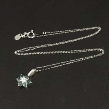 Silver chain necklace with a flower-shaped pendant.
