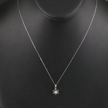 Delicate silver necklace with a star-shaped pendant.