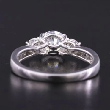 Elegant ring with central round diamond and smaller accent stones.