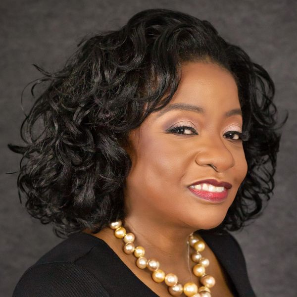 Smiling Black woman with pearls