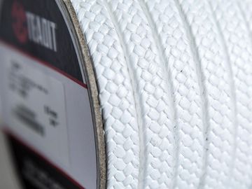 Close-up of a white braided rope on a spool.