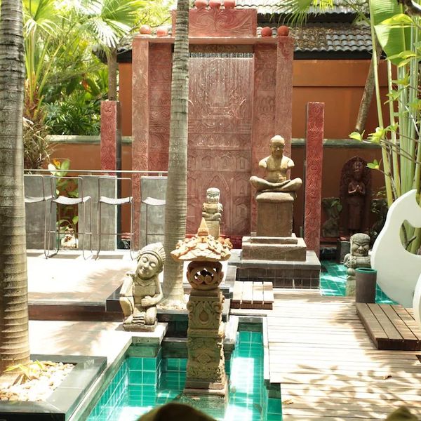 Statues, chair, and water feature