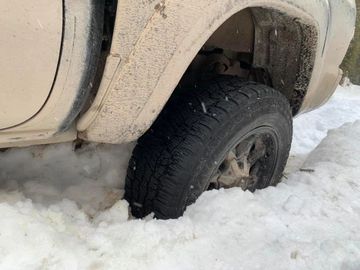 light beige pickup truck stuck in deep snow