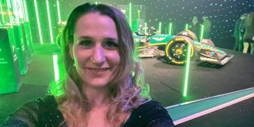 woman in front of a formula one car