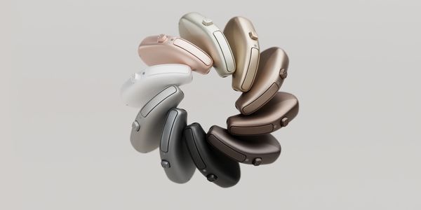 A circular arrangement of sleek hearing aids in various neutral shades.