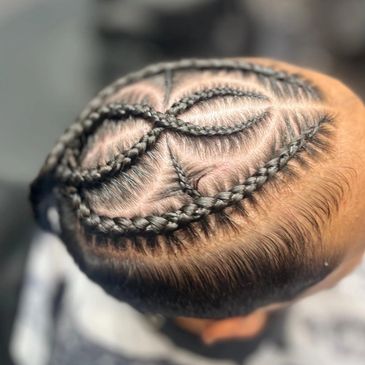Intricate braided hairstyle with geometric patterns on the scalp.