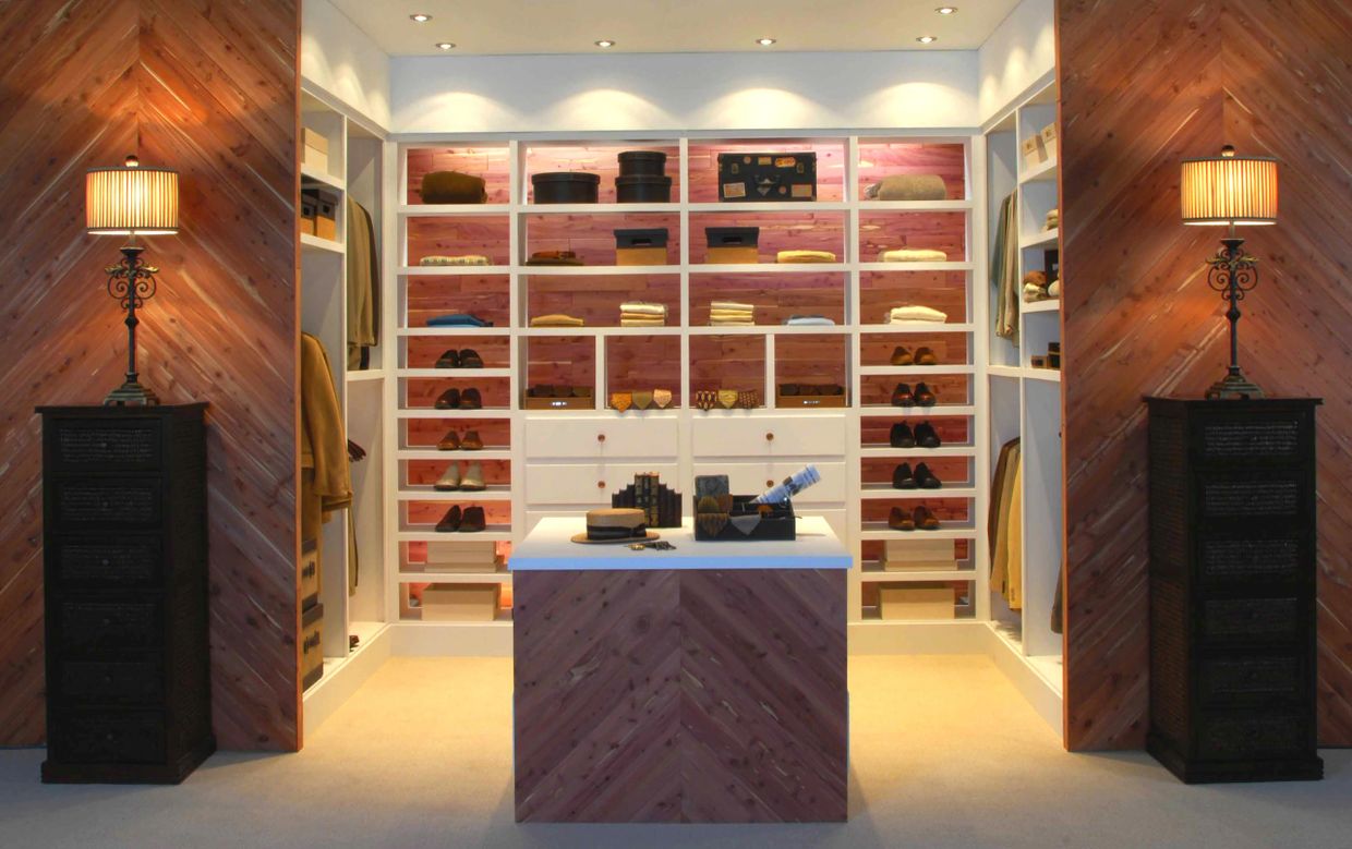 A stylish walk-in closet with wooden accents and organized shelves.