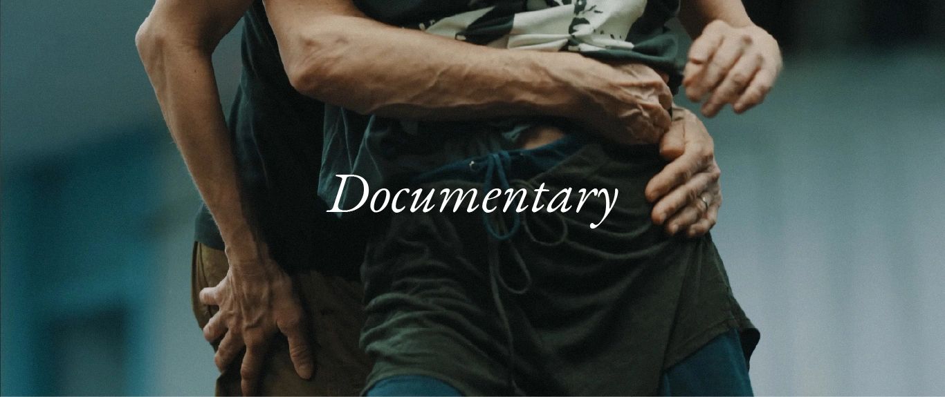 Two people embracing in a documentary scene.