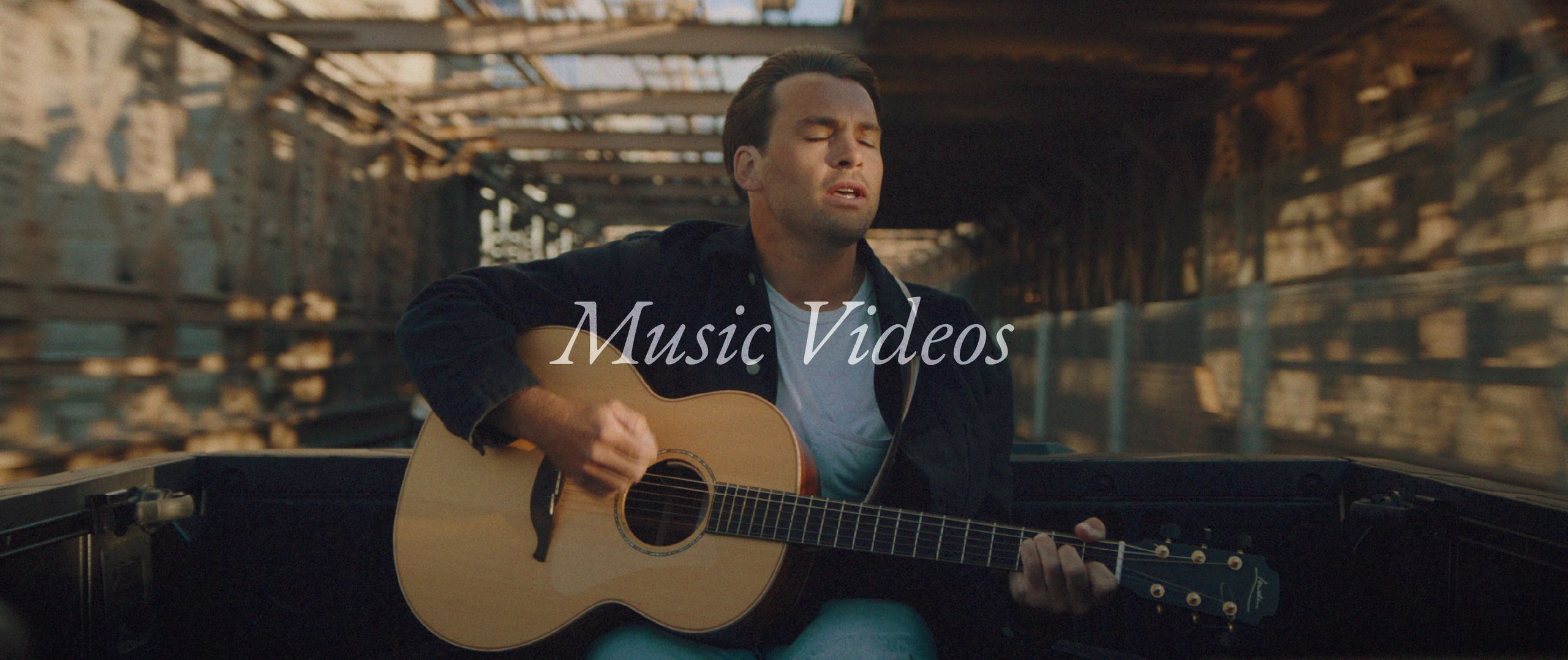 Man playing guitar in a music video.