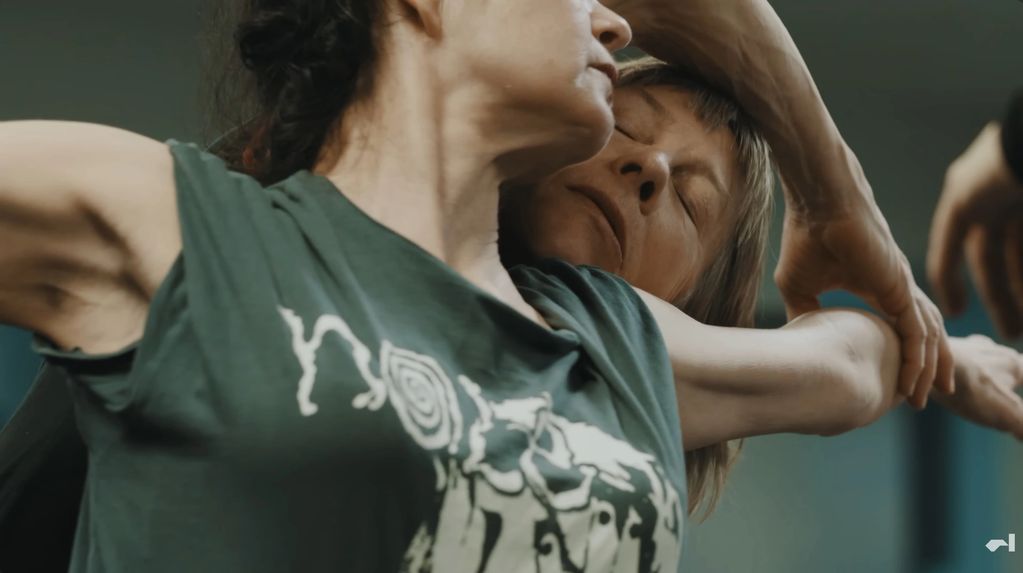 Two women engaging in a close, expressive dance.