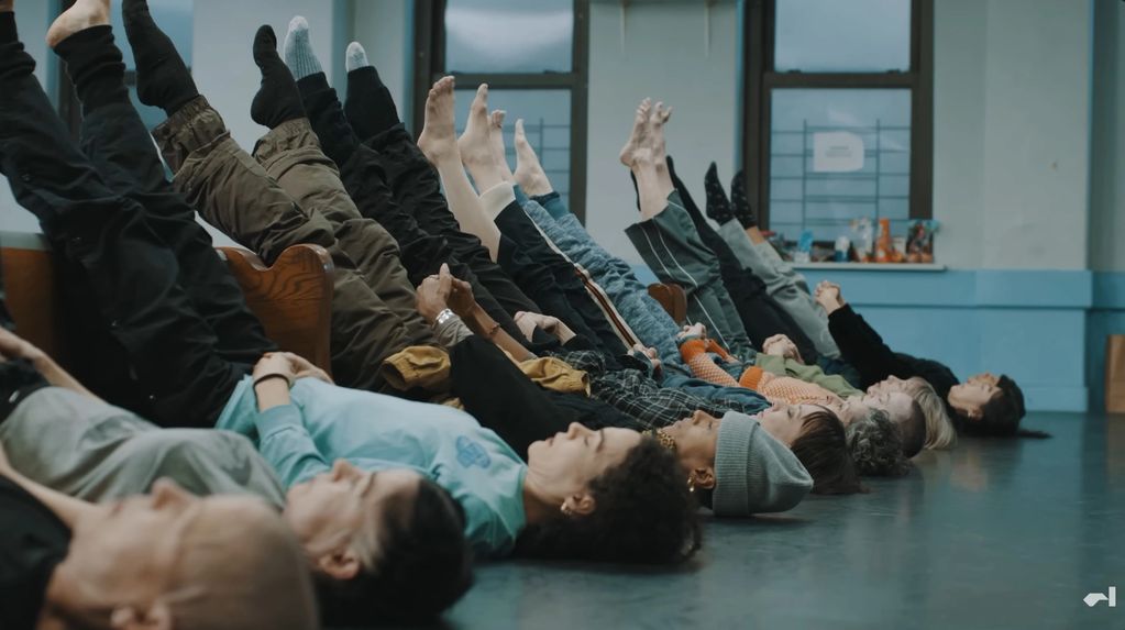 People lying on the floor with legs raised.