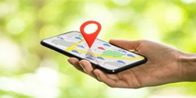 Hand holding a smartphone displaying a map with a location pin.