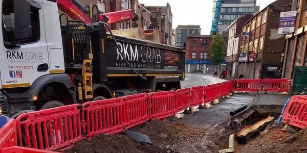 Grab waggon on a road working on utilities 