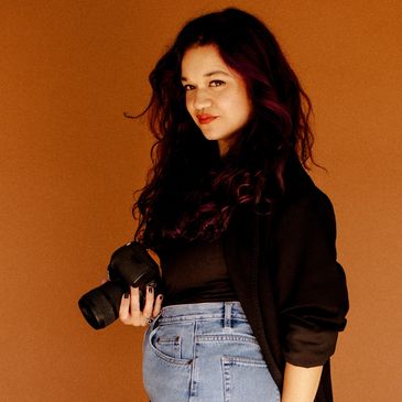 boudoir photographer posing with her camera 