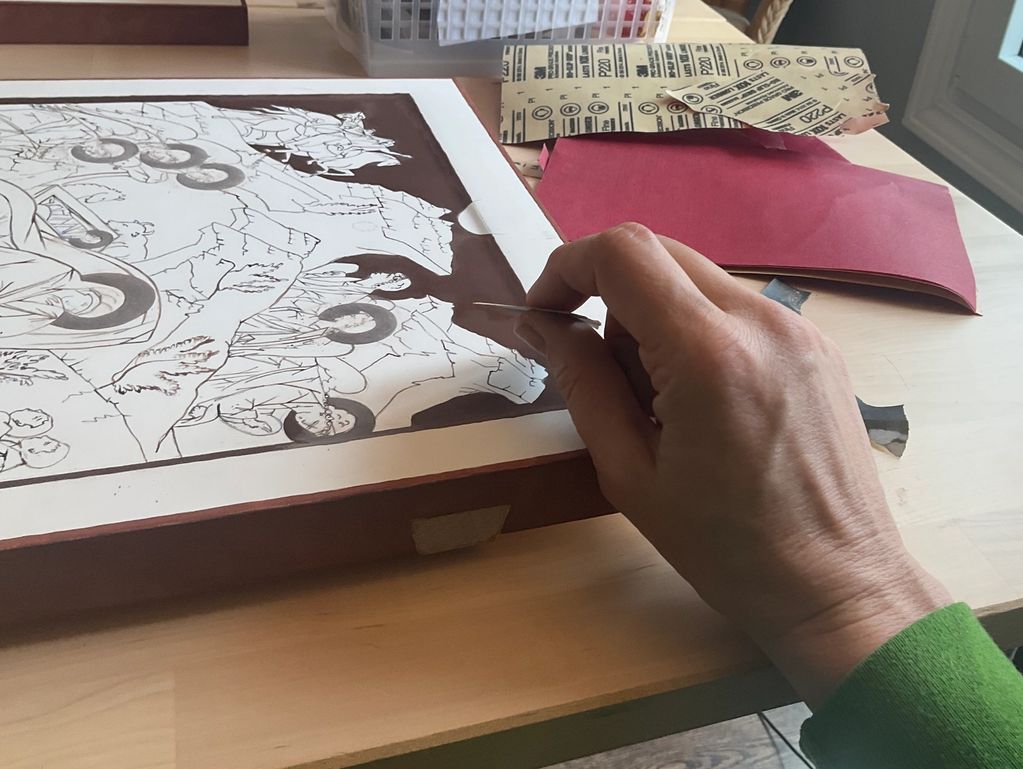 Sanding bole in preparation for burnishing and gilding. 