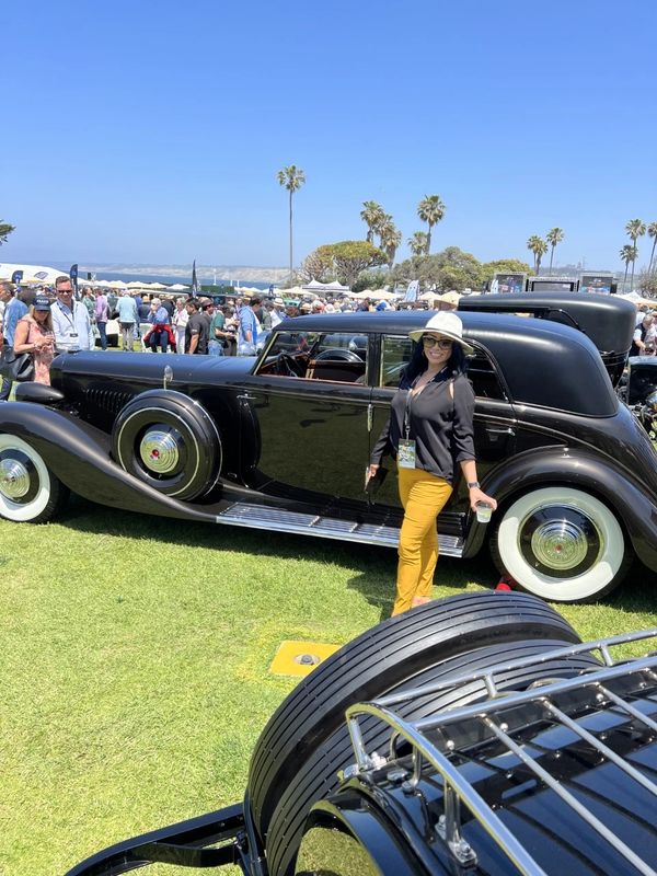 Attorney Dominique pose next to a pristine Duesenberg, Star quality!