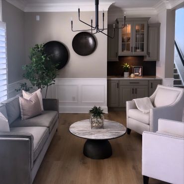 Modern living room with gray furniture and round wall decor.