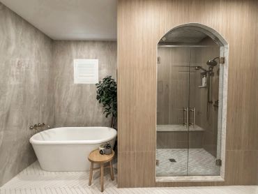 Modern bathroom with bathtub and glass shower.