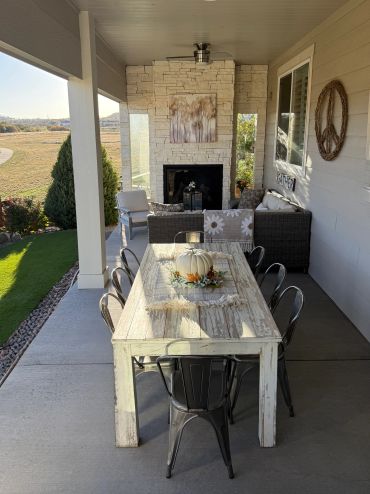 Cozy outdoor patio with rustic dining and seating area.