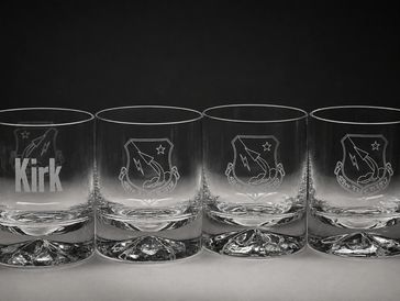 Set of four engraved glasses with Star Trek insignia and one with 'Kirk' name.