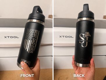 Black water bottle with custom designs on front and back.