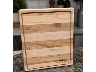 Wooden cutting board with groove edges on a kitchen counter.