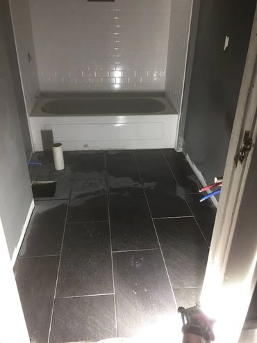 Bathroom flooring and tub surround installation 