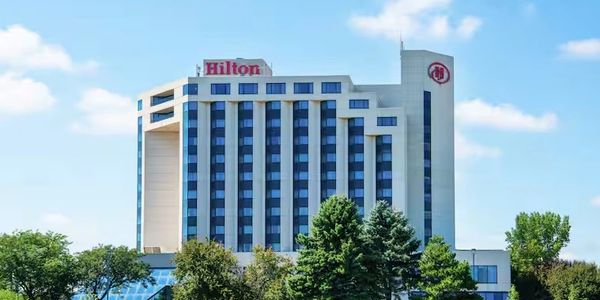A Hilton hotel building under a clear blue sky.
