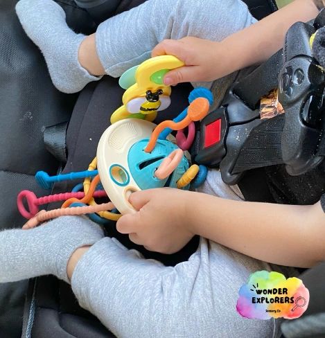 Multi-sensory silicone activity toy (and suction cup spinner) being played with in the car