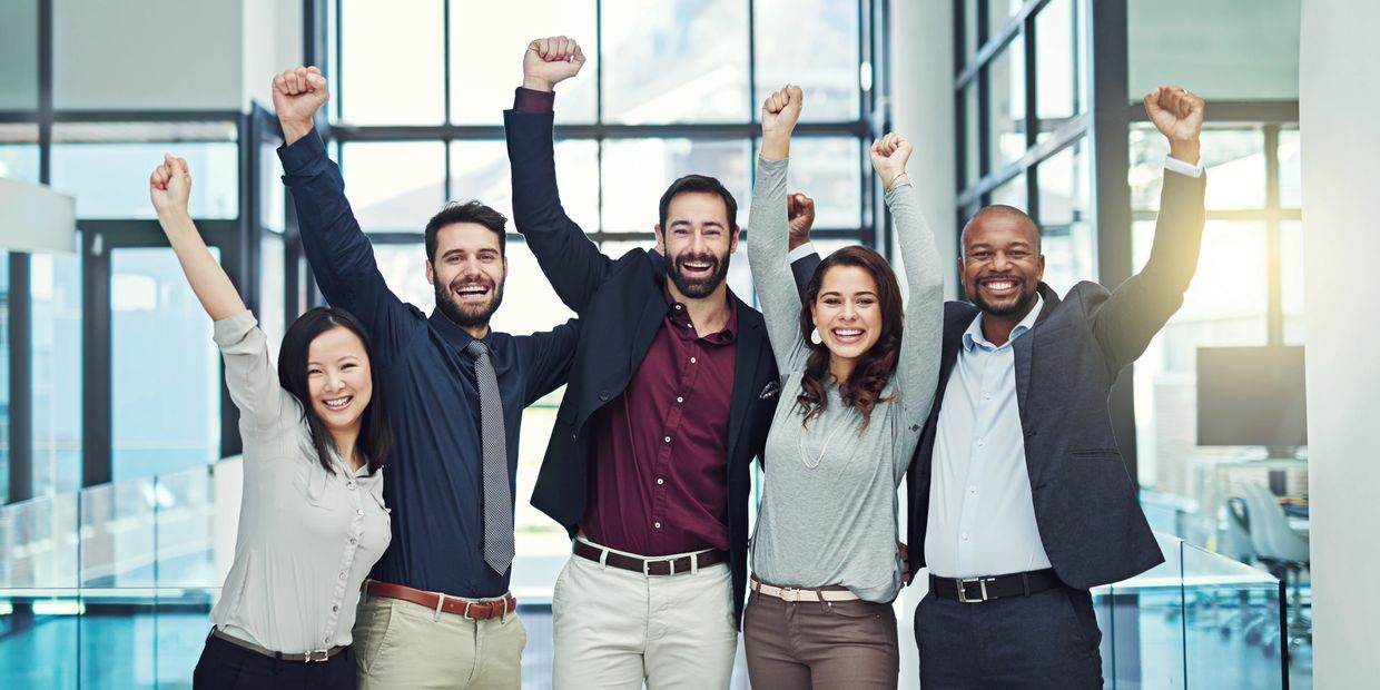 group of people with their hands up in the air smiling 