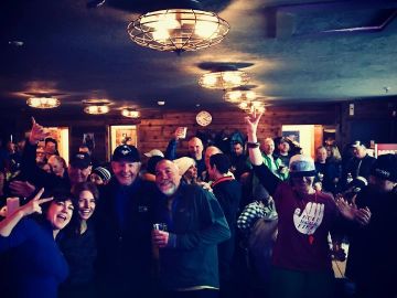 A lively group of people enjoying a social gathering indoors.