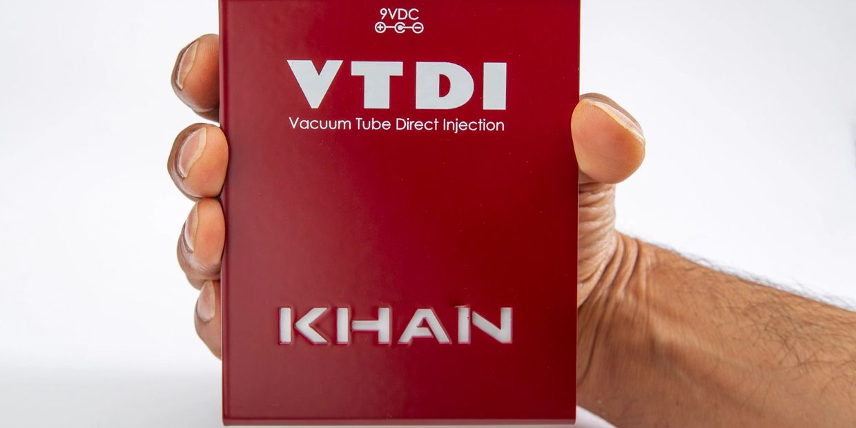 Red Khan 9VDI audio device with input, thru, and balanced output ports.