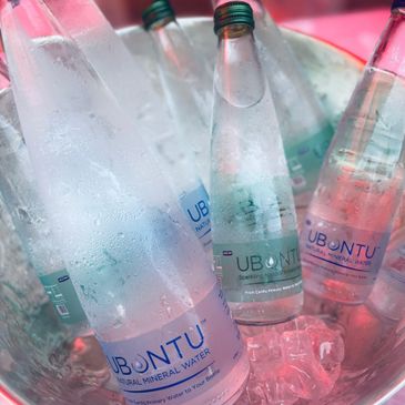 Bottles of Ubuntu natural mineral water chilling in ice.