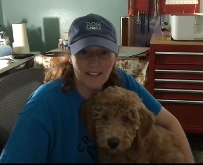 Closeup shot of woman holding her dog