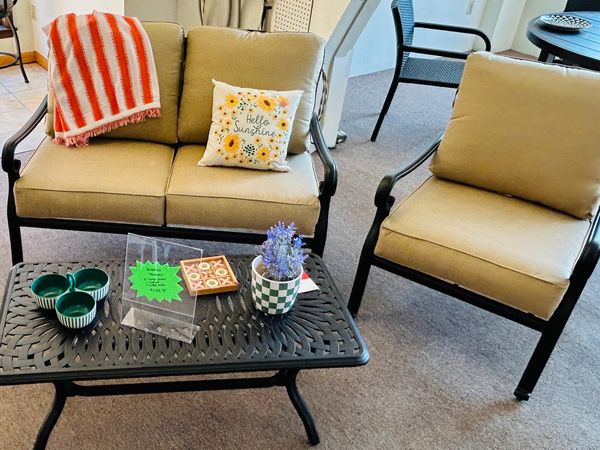 Cozy indoor seating area with cushioned chairs and a coffee table.