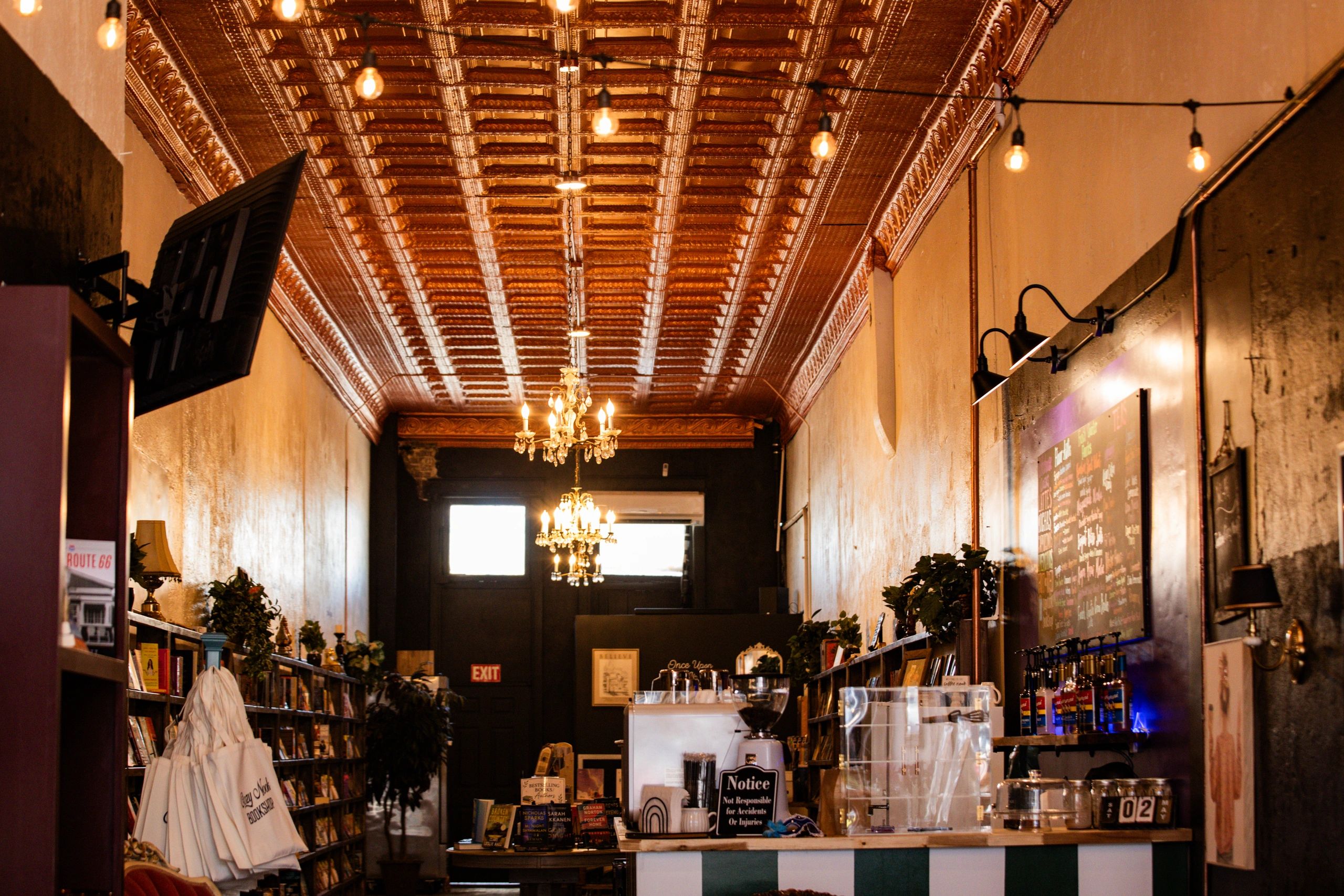 Cozy bookstore cafe with warm lighting.