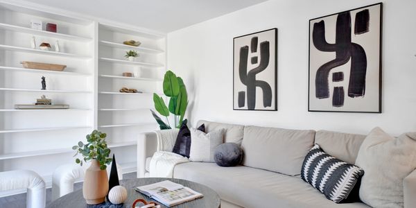 Modern living room with abstract art and cozy sofa.