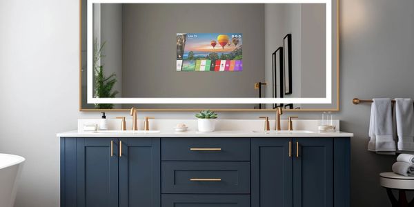 Modern bathroom vanity with smart mirror displaying TV interface.