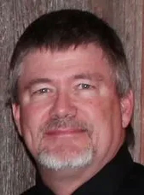 A close up of a man smiling.
