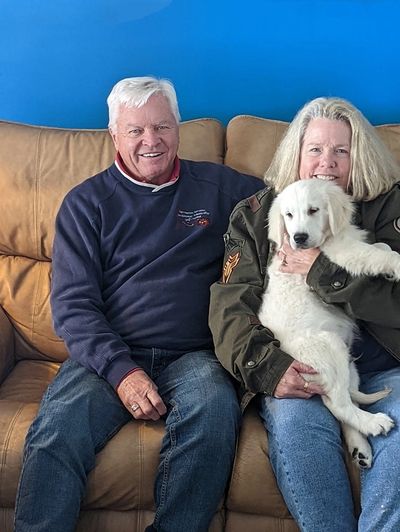 Cunningham family with their puppy they boarded with Snowy River Golden Retriever Breeders.