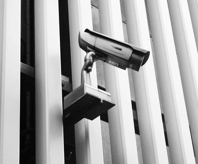 black and white image of a security camera on the building
