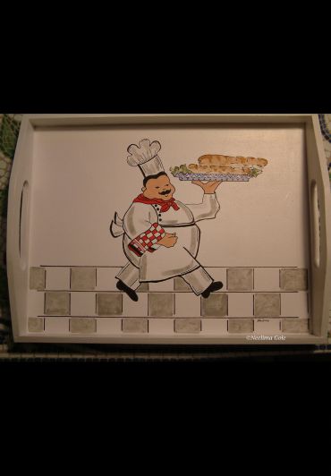 Decorative tray with cartoon chef holding a sandwich tray.